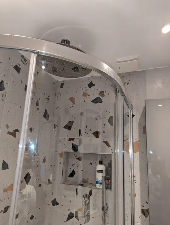 Quadrant shower enclosure with speckled terrazzo style tiles